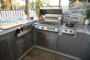 Outdoor kitchen with stainless steel grill and stove on a patio