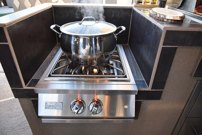 Stainless steel pot on a gas stove with steam rising, set against a modern kitchen backdrop.