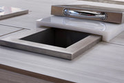 Stainless steel sink embedded in a wooden countertop with a metallic handle.