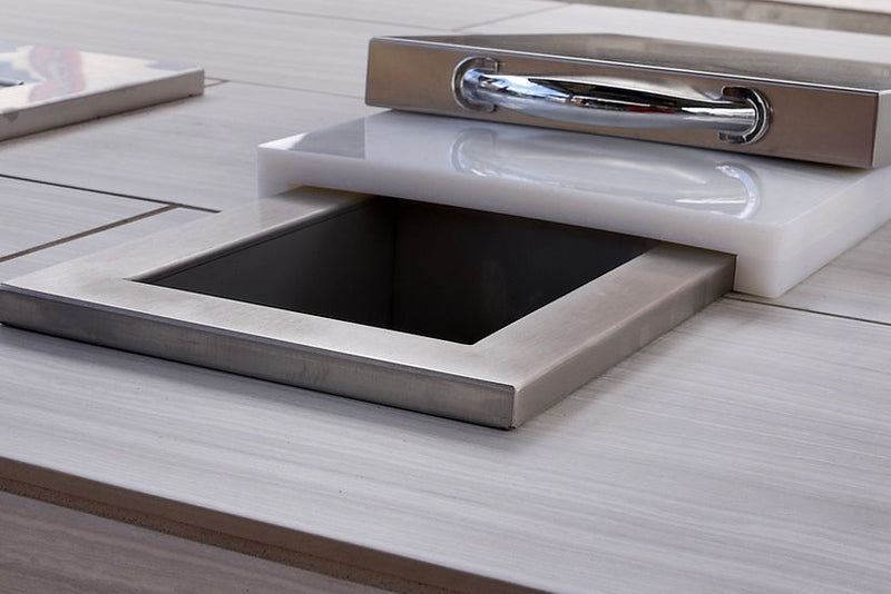 Stainless steel sink embedded in a wooden countertop with a metallic handle.