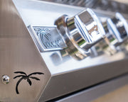 Close-up of a metallic surface with a palm tree logo and branding.