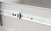 Close-up of a metal cabinet drawer slide mechanism.