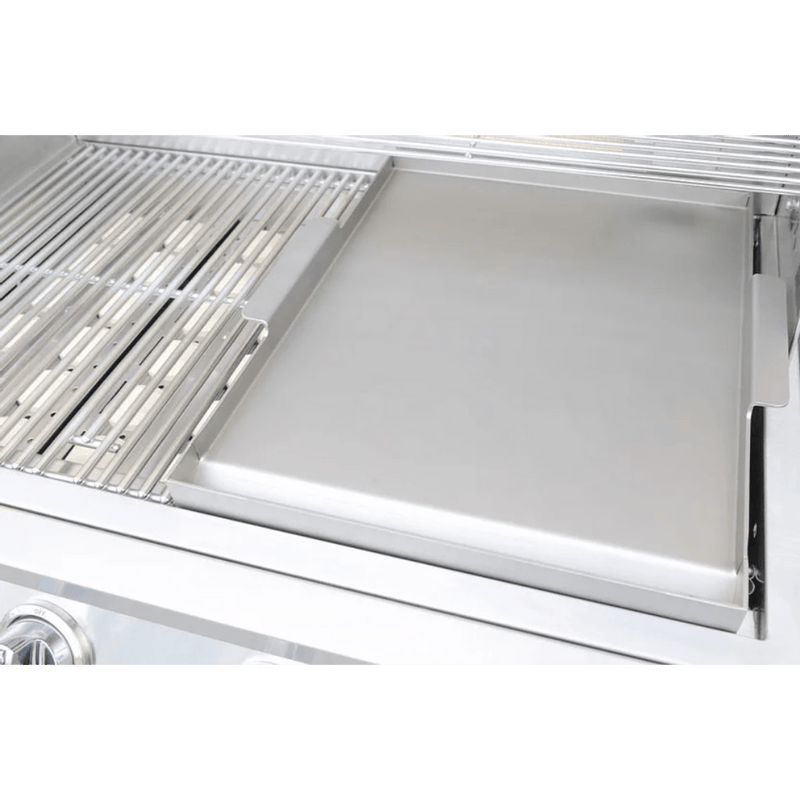 Stainless steel grill with a cover open on a green background