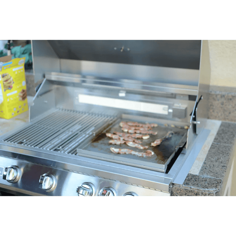 Stainless steel outdoor grill with food on a countertop
