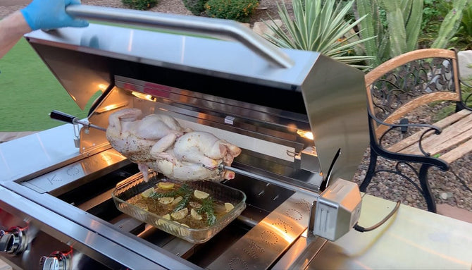 Stainless steel grill with a turkey being roasted outdoors